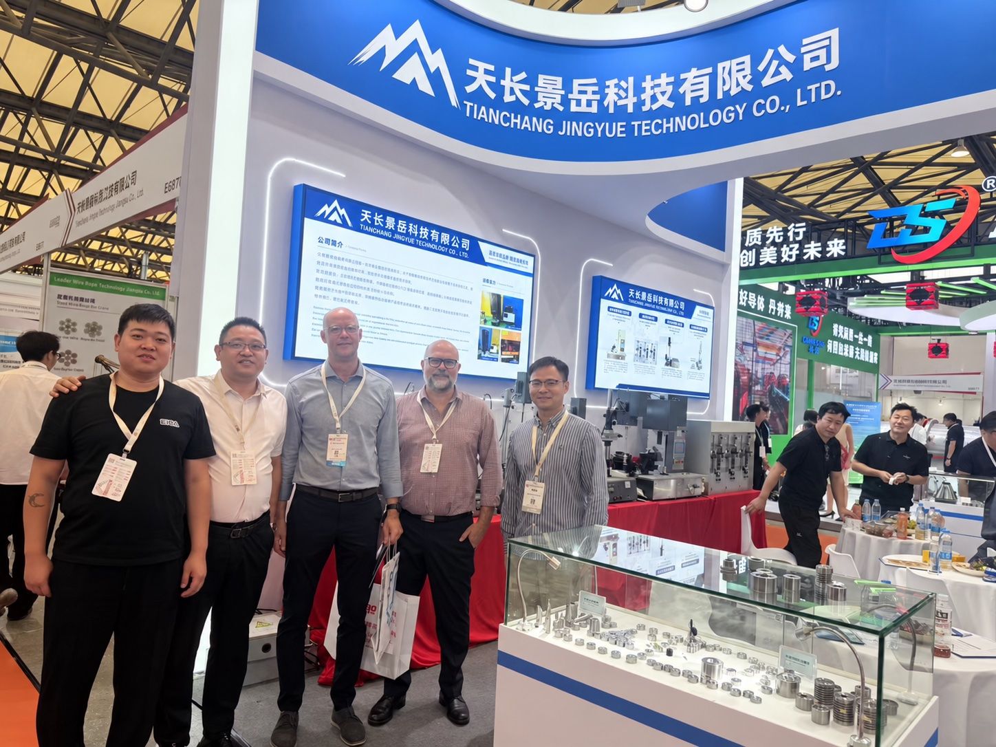 Jingyue team with visitors beside wire drawing dies at wire China 2026